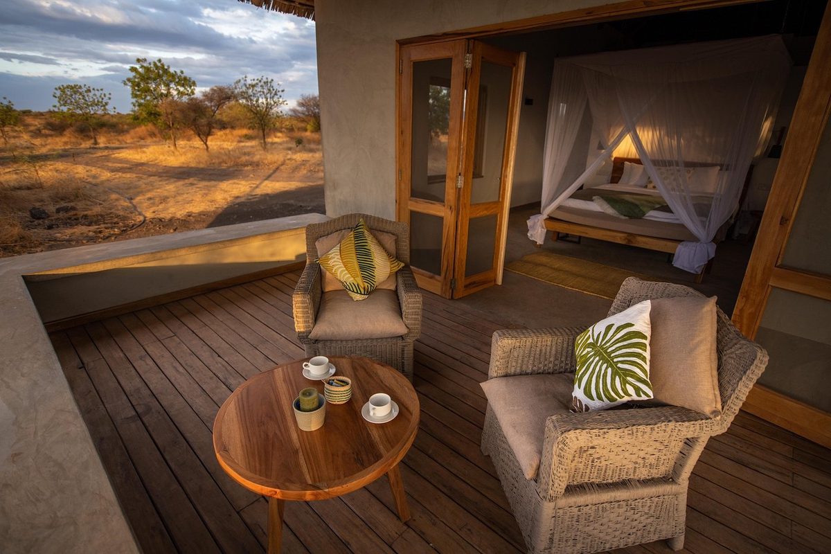Terrace with seating and a view into the room with the bed