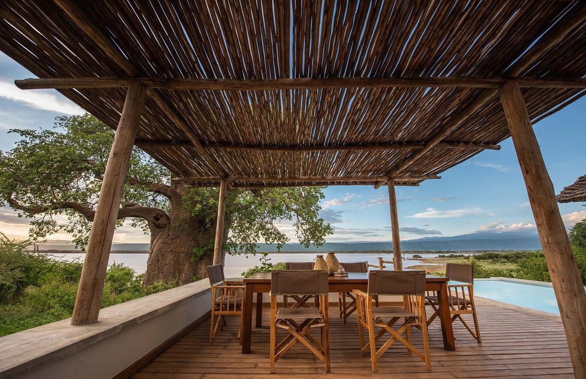 Covered terrace with dining table and views of the lake
