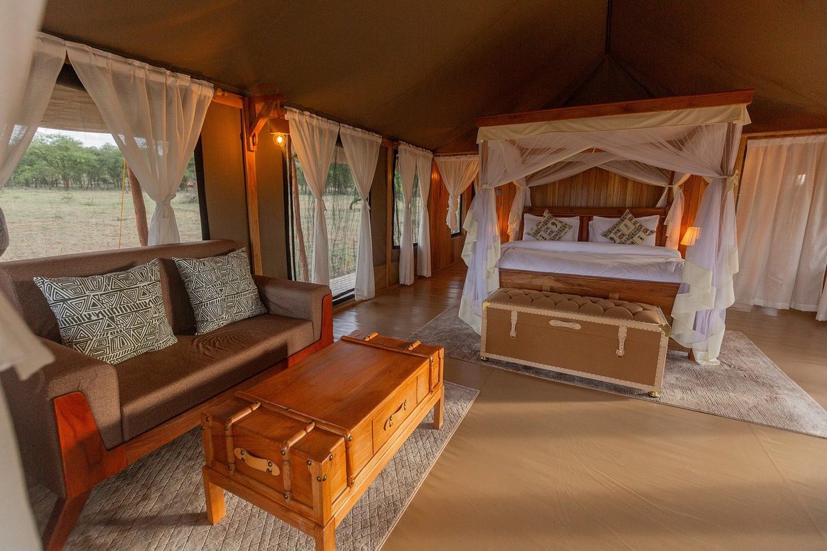 Tent interior with bed and seating area
