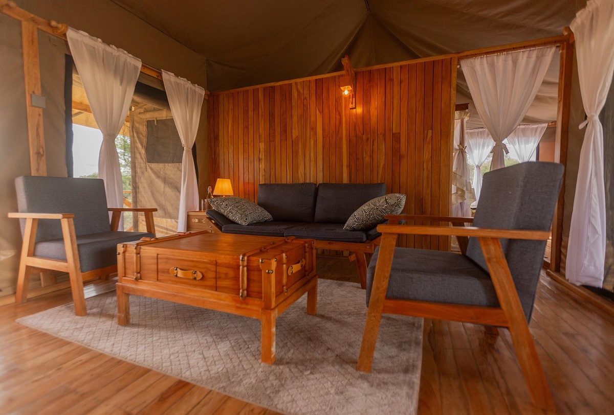 Lounge in the tent with seating furniture and wood panelling