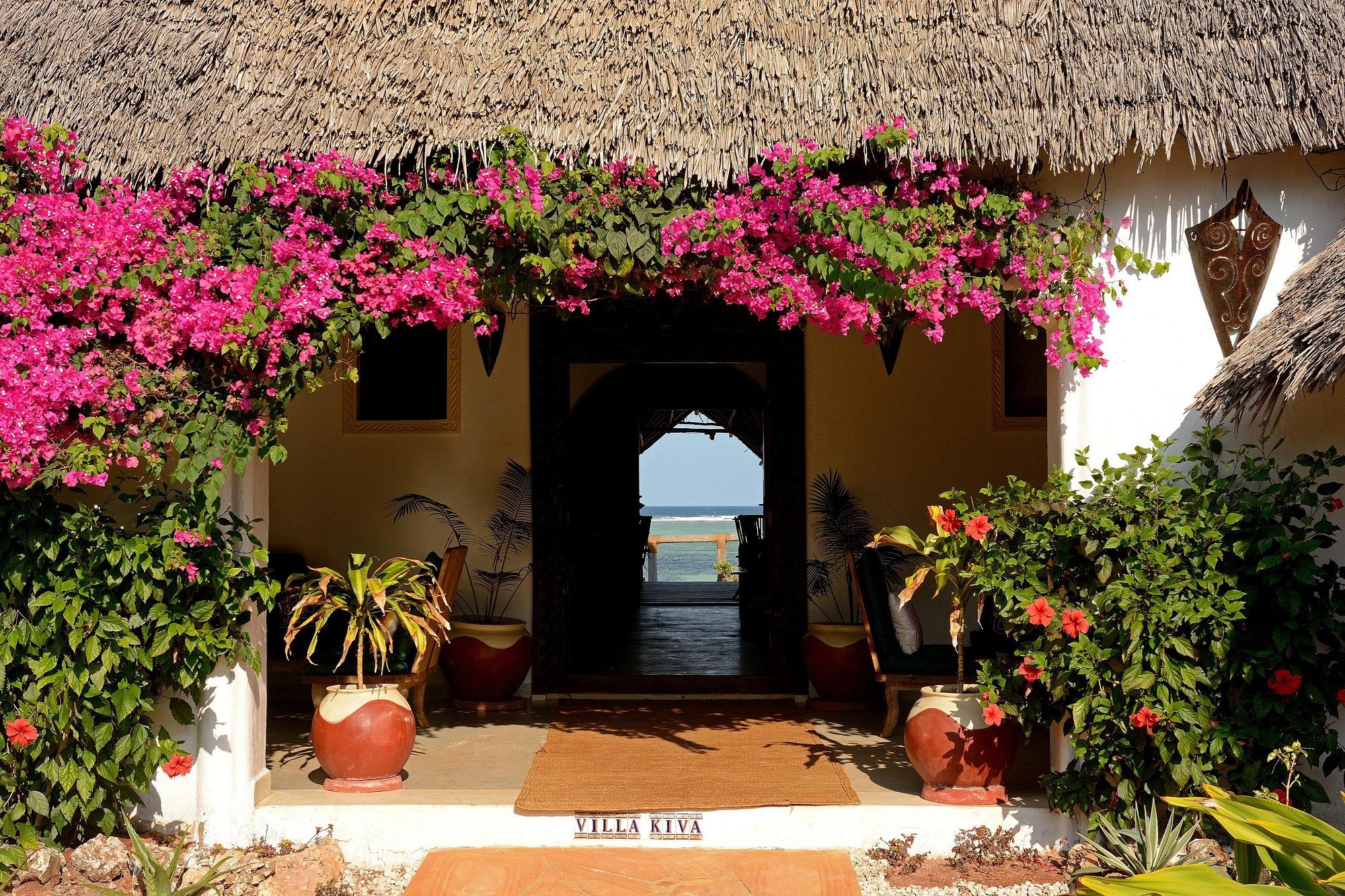 House entrance with flowers and name on the doormat