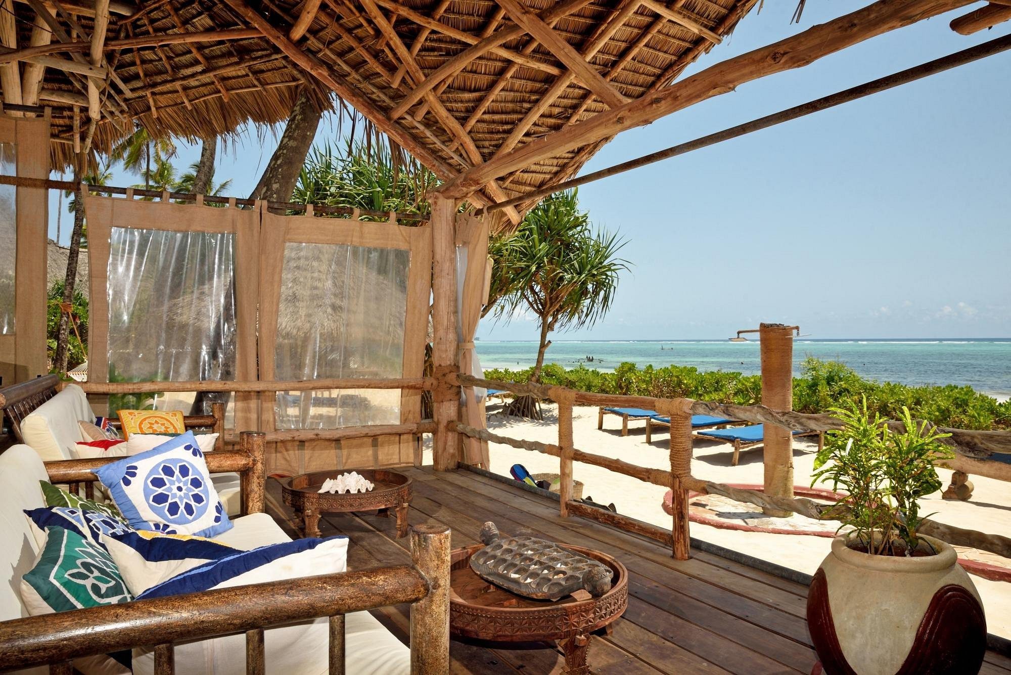 Covered terrace with seating and sea views